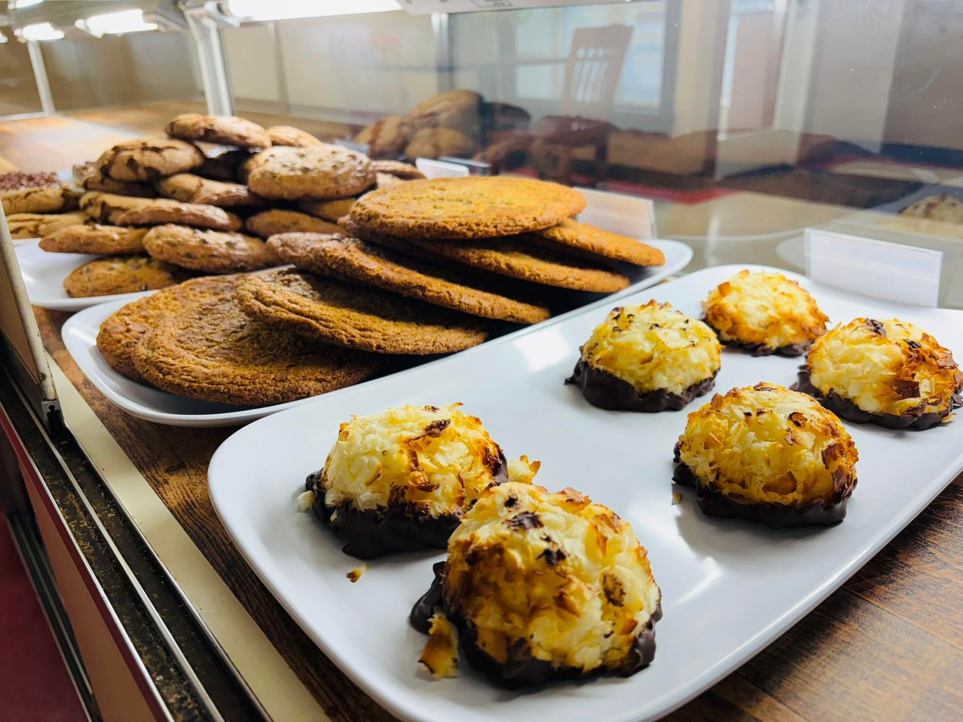 Cookies on display: chocolate chip, large round, and coconut macaroons dipped in chocolate.