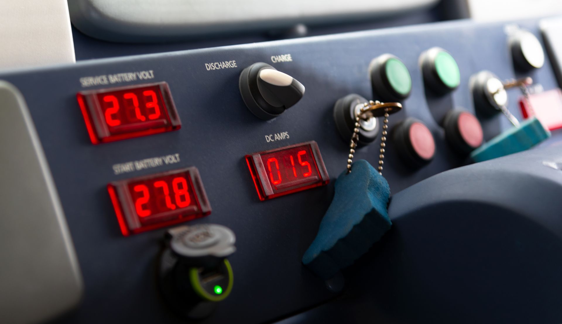 Dashboard with red digital displays showing voltage readings, and various buttons and switches.