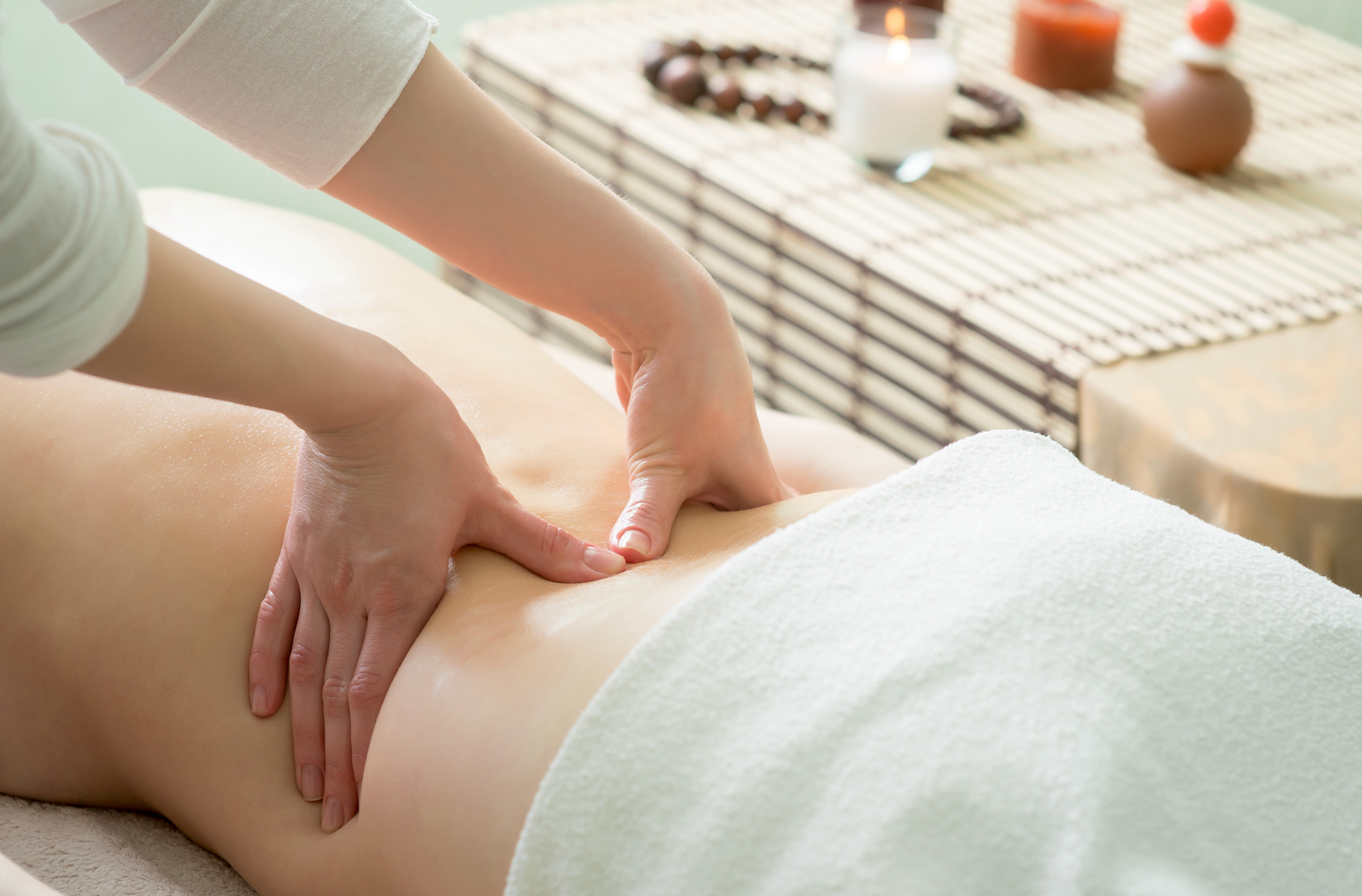 A woman is getting a massage on her back in a spa.