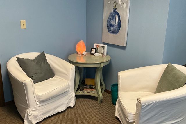 A room with two chairs and a table in it