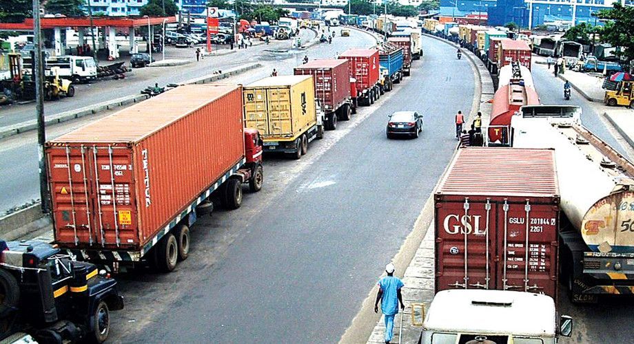 A gsl shipping container is parked on the side of the road