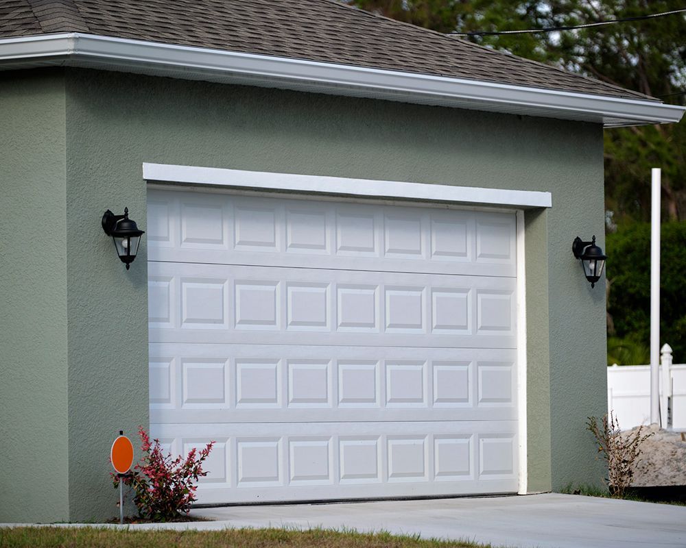 Green House with White Garage Door — Haverstraw, NY — Delco Overhead Door Co