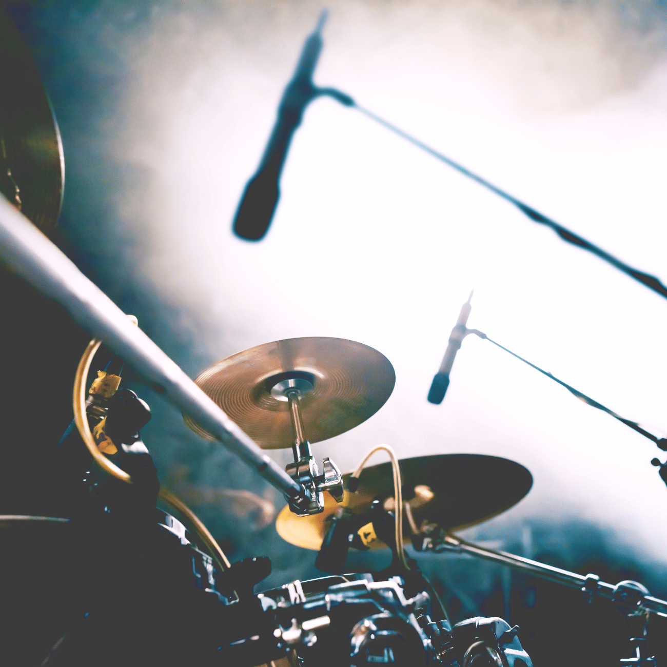 A drum set with a microphone hanging from it