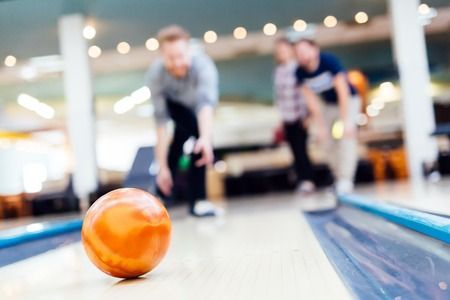 A bowling alley with a bunch of bowling balls in it.