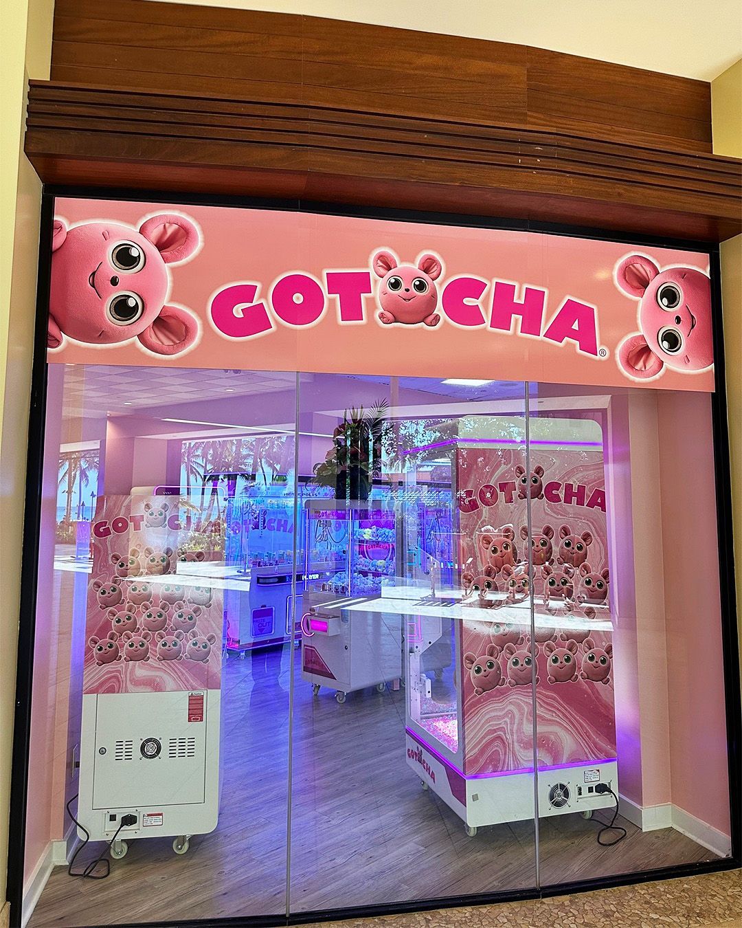 A store front with a pink sign that says gotcha
