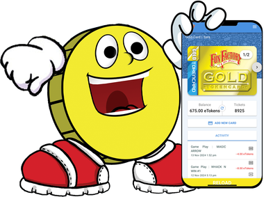 A yellow smiley face is standing next to a cell phone.
