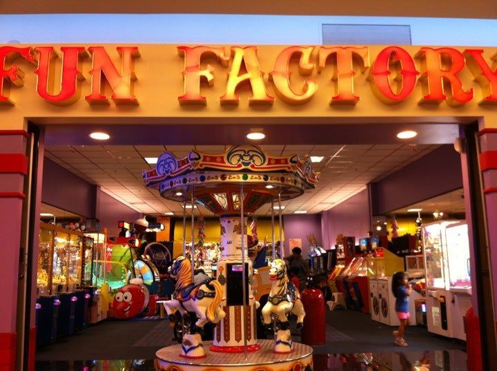 The inside of a fun factory with a merry go round