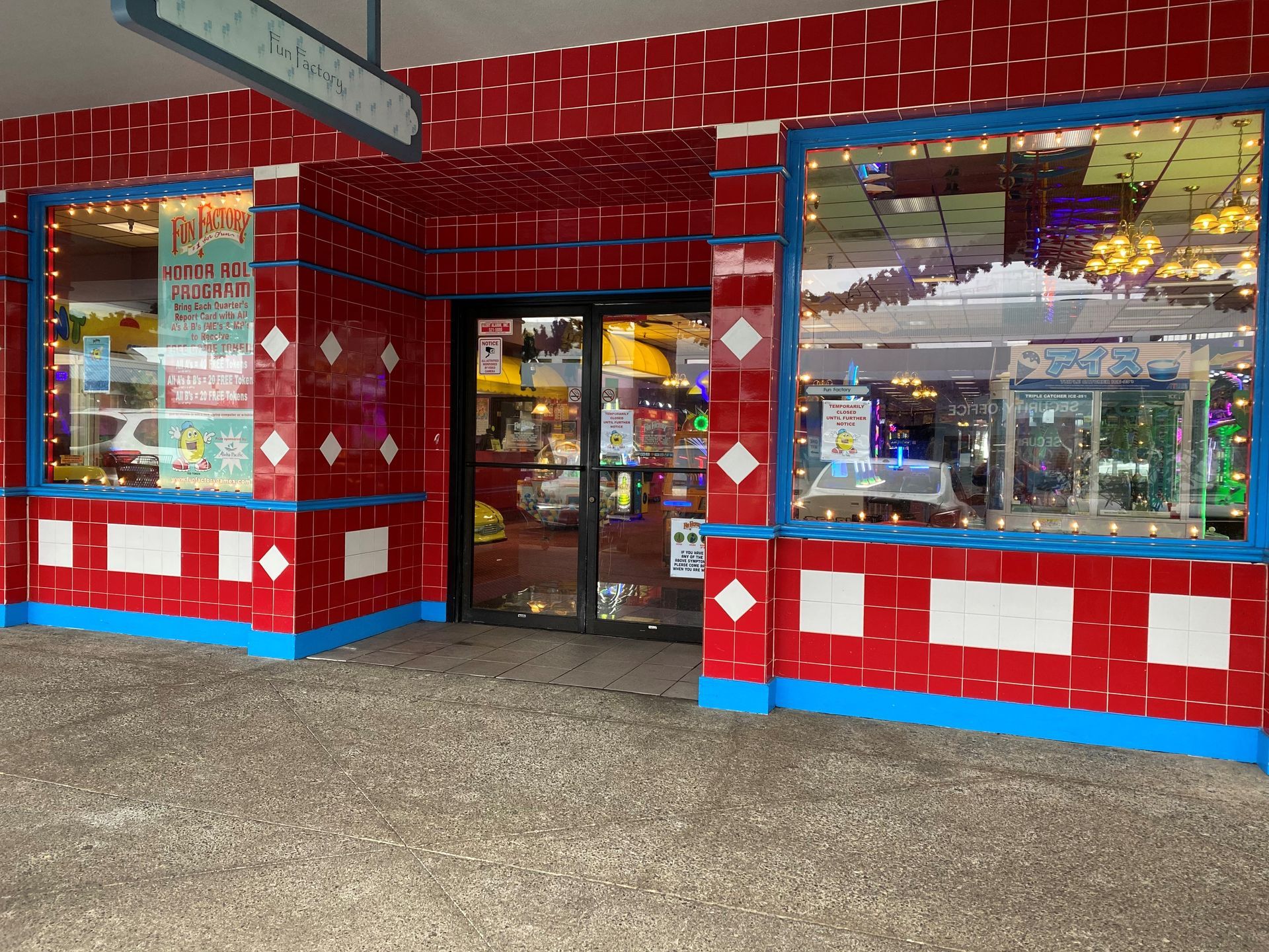 A red and blue building with a glass door and windows.