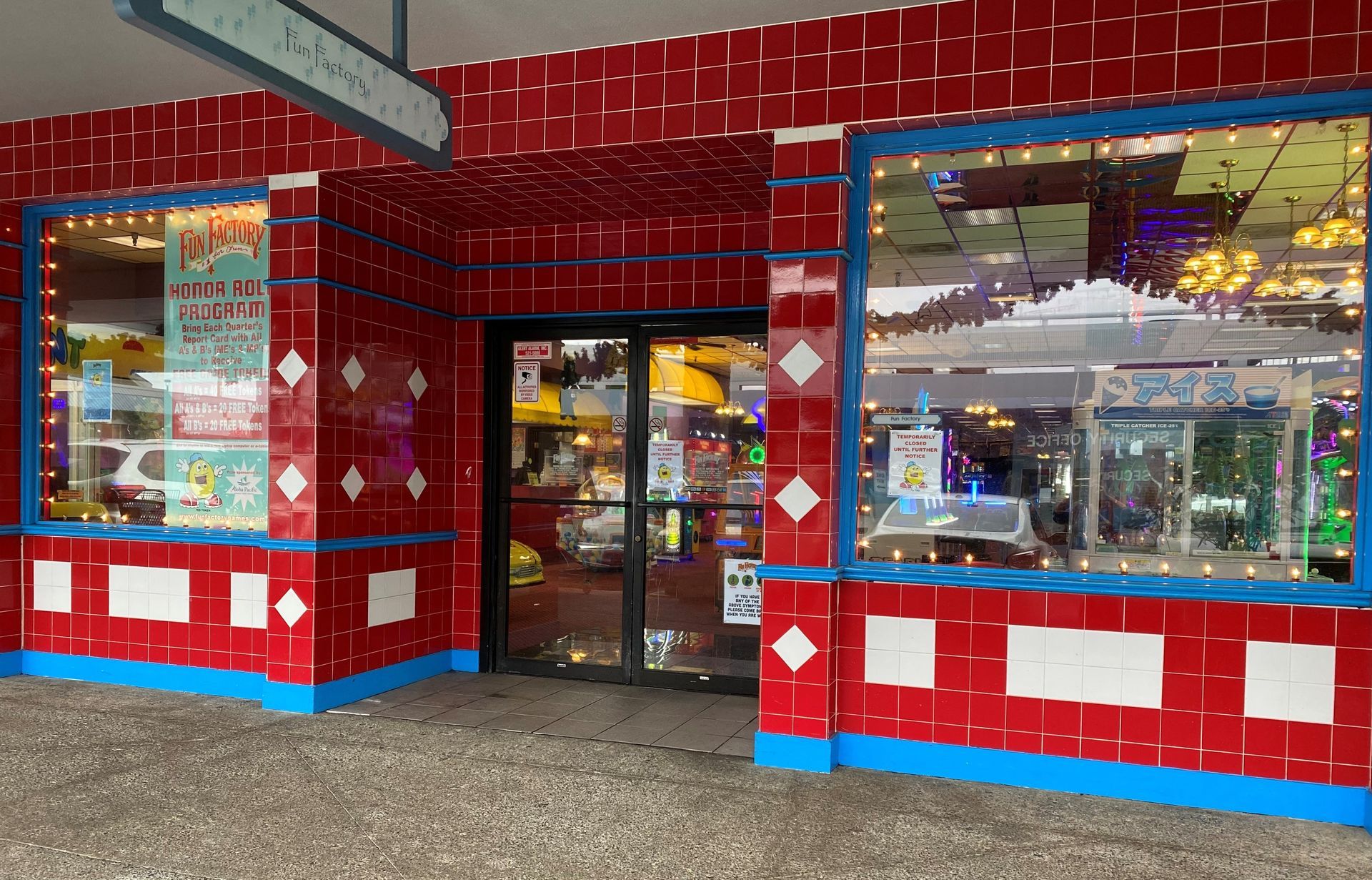 A red and blue building with a door and windows.