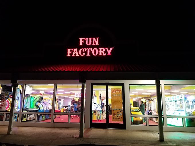 The front of a fun factory arcade at night.