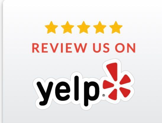 A yelp logo that says review us on