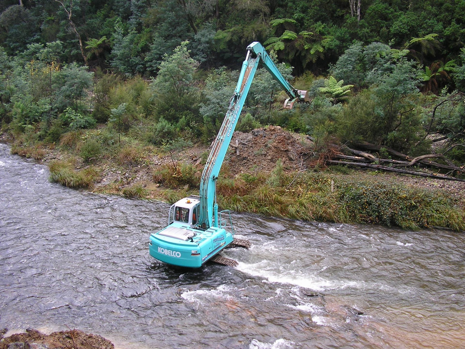 Two excavators are working on a construction site.