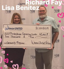 A man and a woman are holding a check for $ 2,000. A man and a woman are holding a check for $ 2,000.