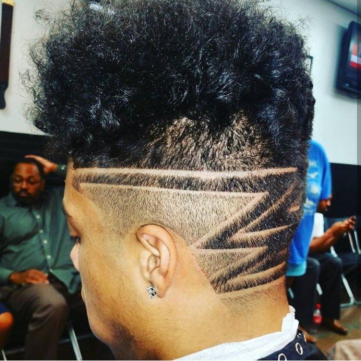 A man with a mohawk has a lightning bolt design in his hair