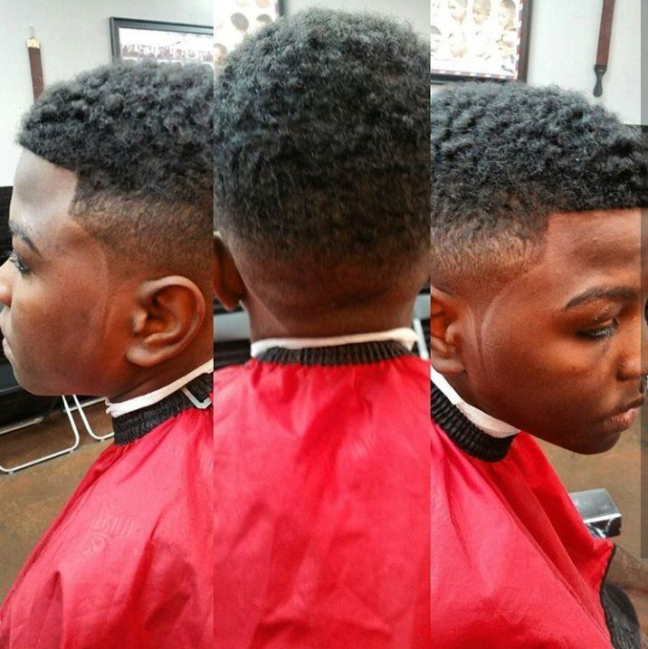 A man in a red cape is getting his hair cut