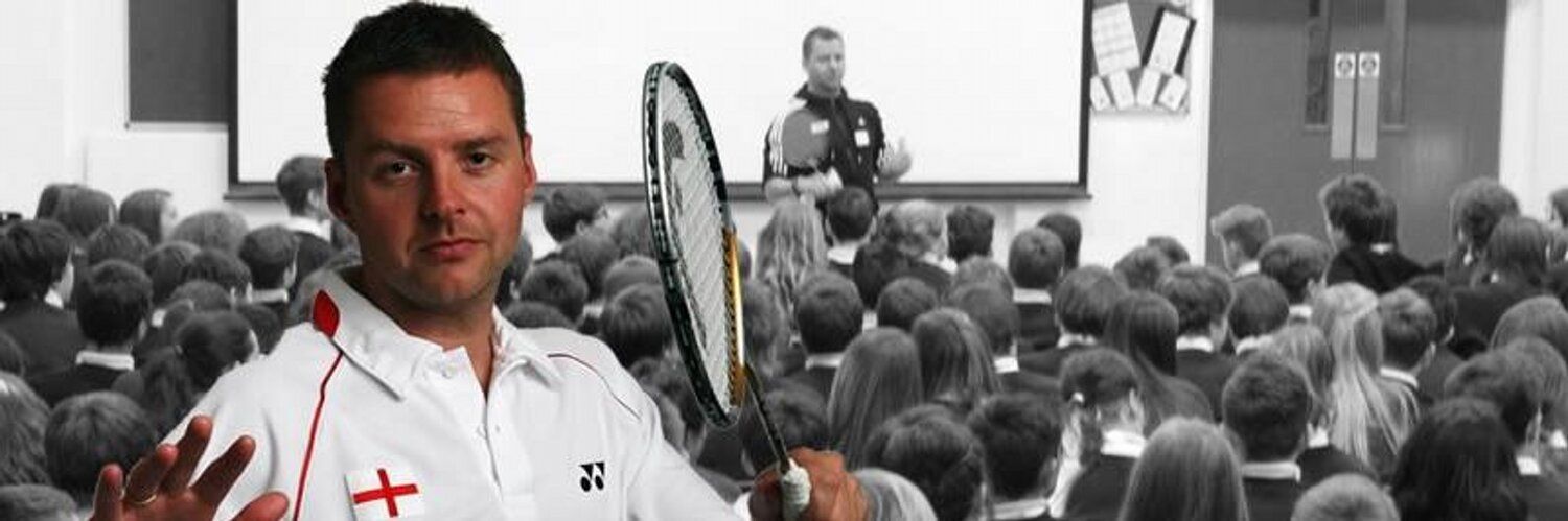 A man holding a tennis racquet in front of a crowd