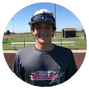 Smiling baseball player in gray Atlanta Astros shirt on a sunny field