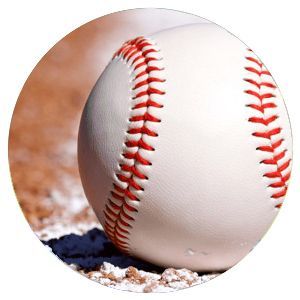 Close-up of a white baseball with red stitching resting on dirt and chalk