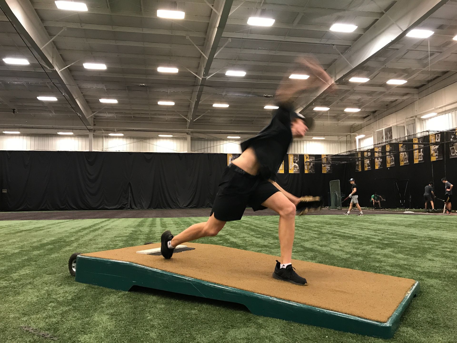Athlete lunging on a slanted platform in an indoor training facility