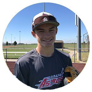 Smiling baseball player in Astros shirt and cap holding a glove on a sunny field