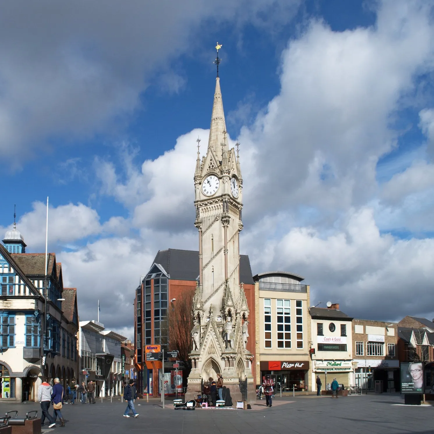 A large clock tower in the middle of a city