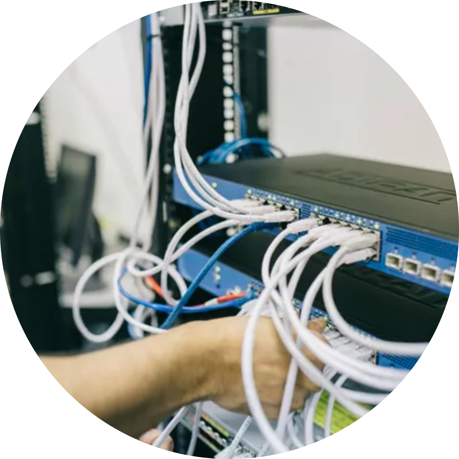 A man is working on a server in a data center.