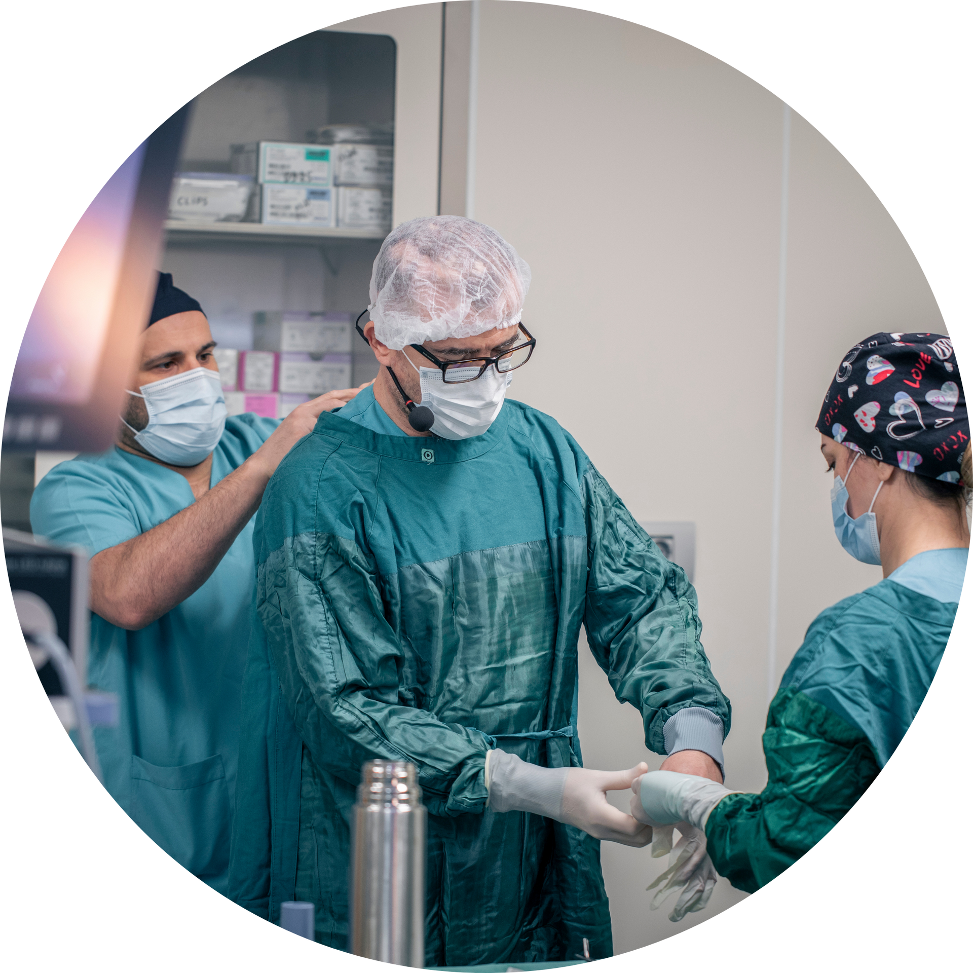 A group of surgeons are preparing for surgery in an operating room.