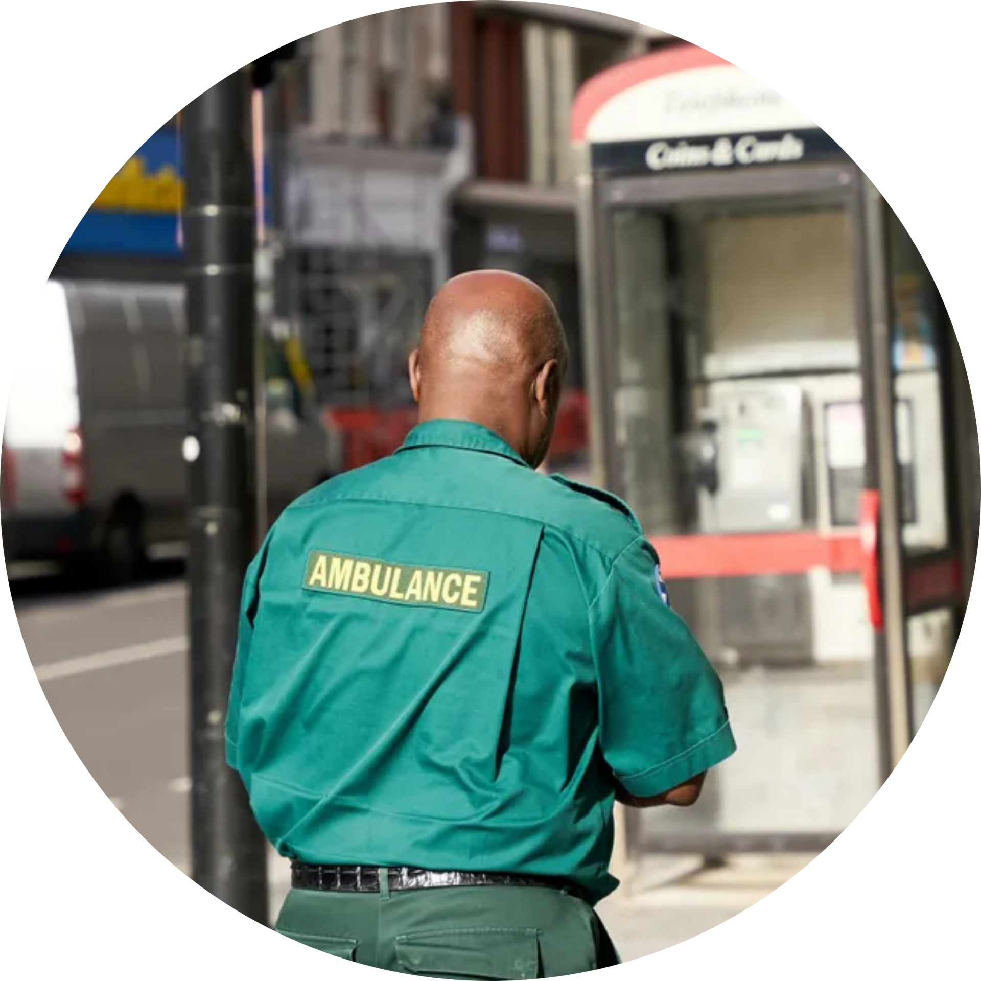 A man in an ambulance uniform is walking down the street