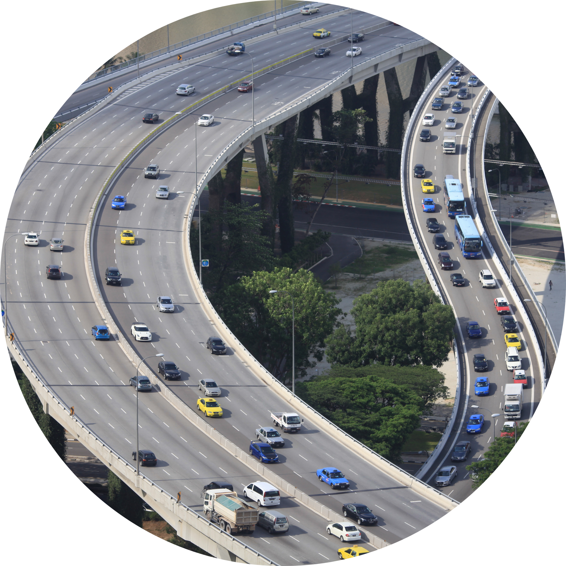 An aerial view of a highway with a city in the background