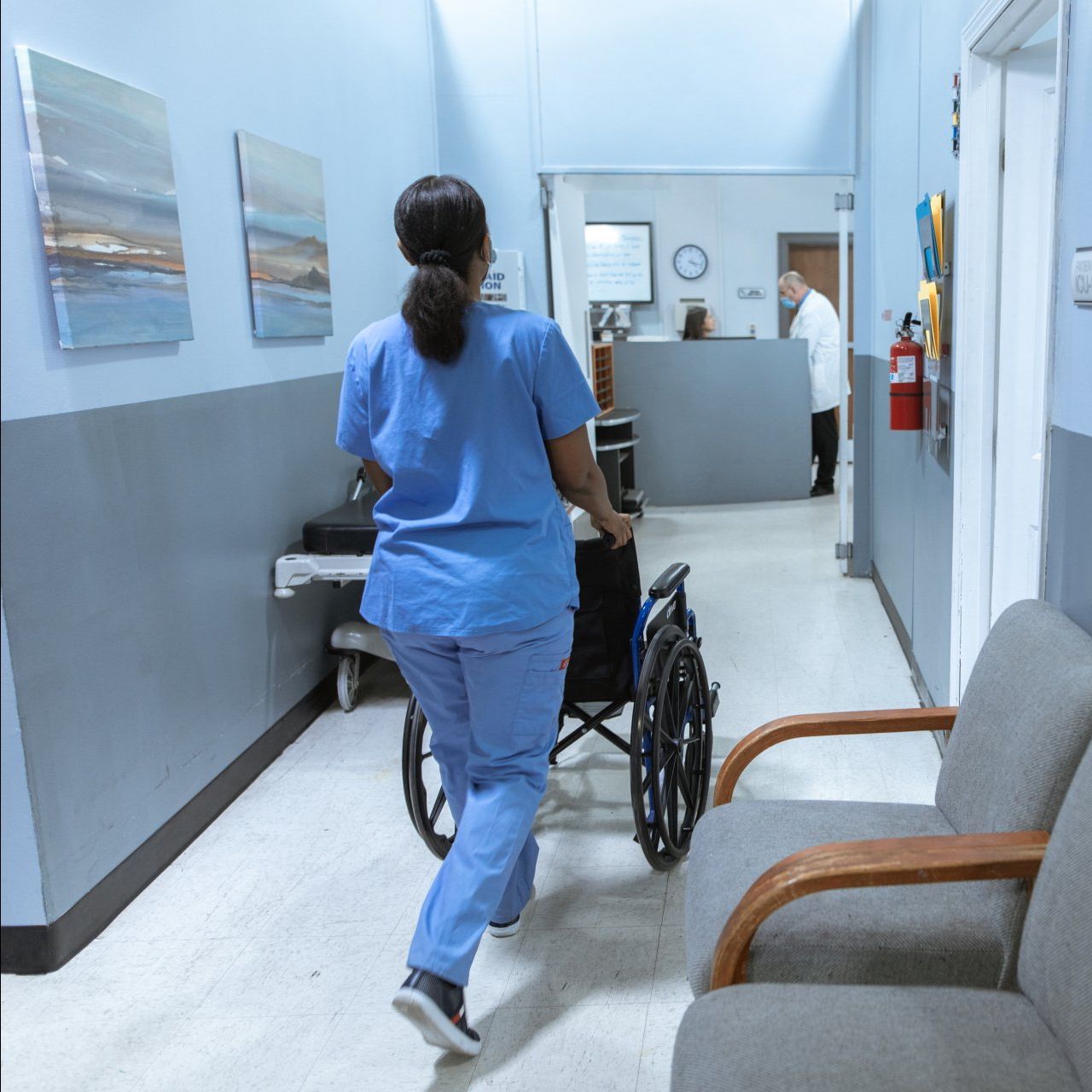 A Nurse pushing a wheel chair