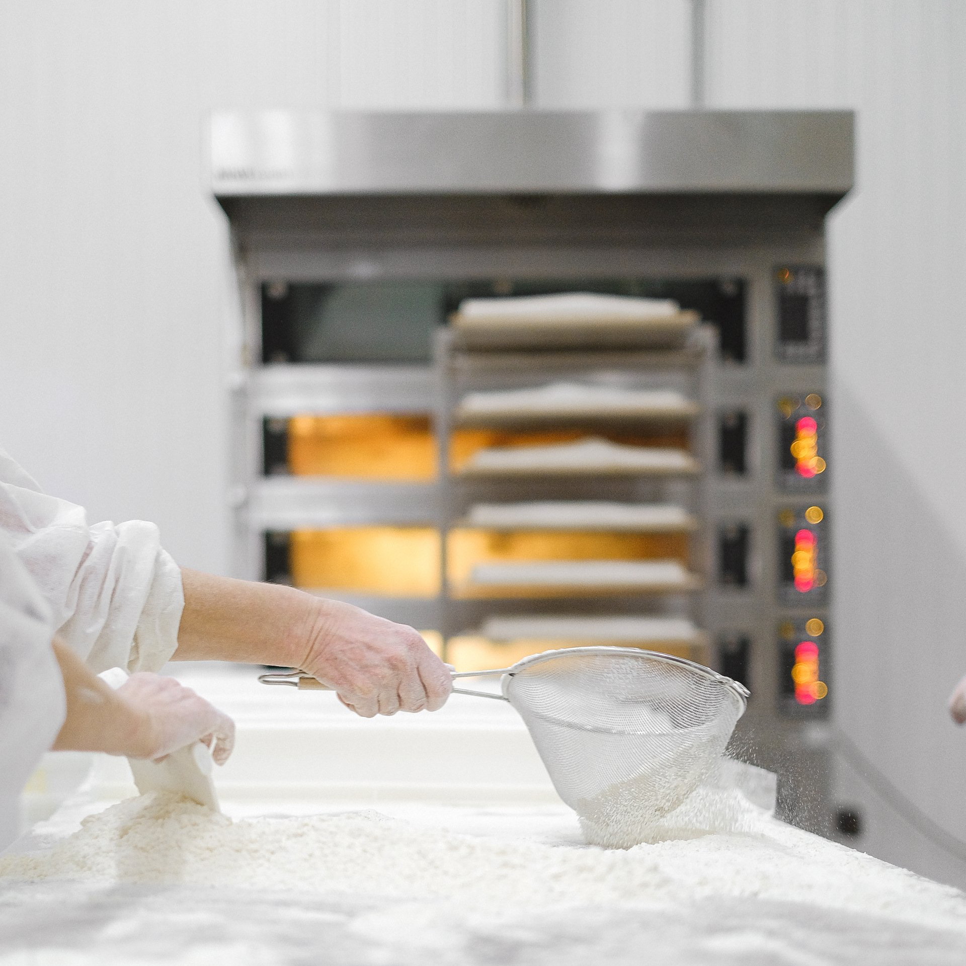 Worker sifting flour