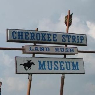 A sign for the cherokee strip land rush museum