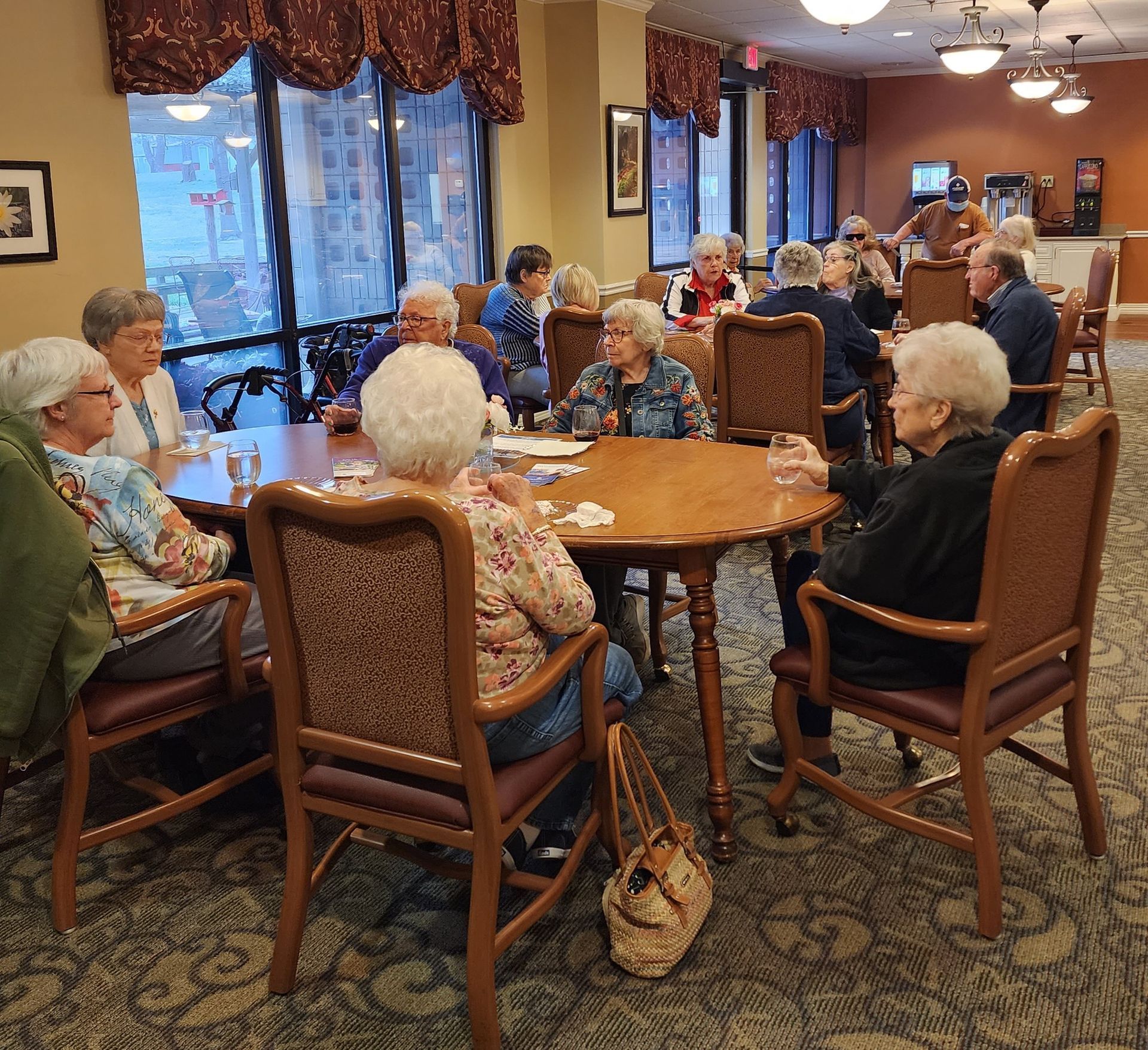 A group of people are sitting around a table in a room