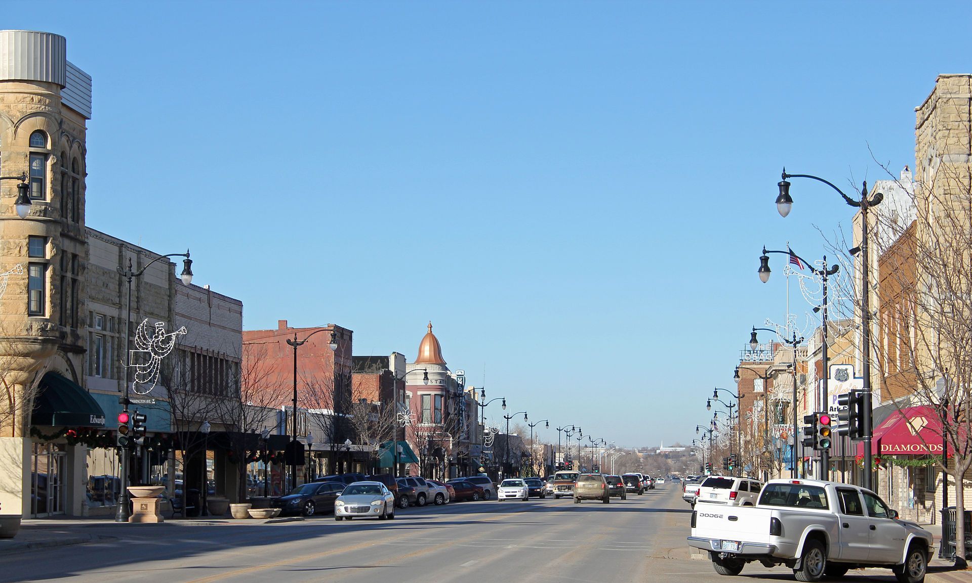 A white truck is parked on the side of a city street