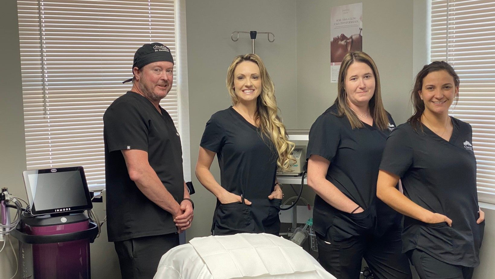 A group of people standing next to each other in a room.