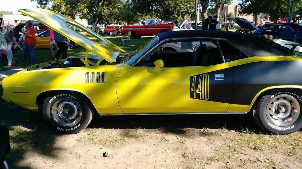 A yellow and black car with the hood open