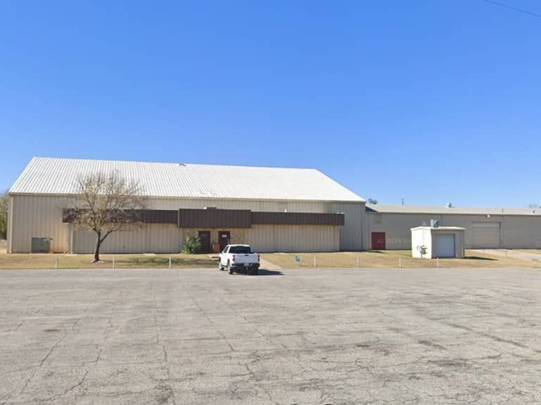 Agri-business building Ark City, KS A white truck is parked in front of a large building.