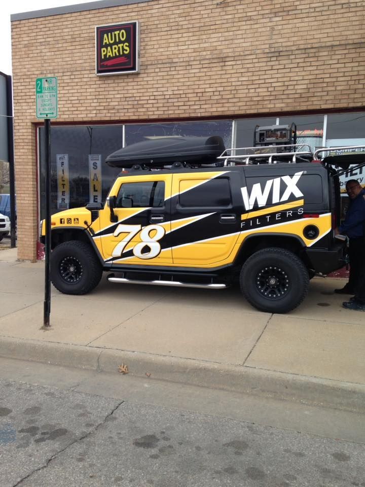 A yellow and black vehicle with the word wix on the back