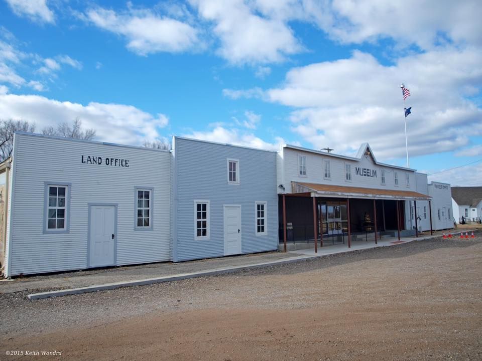 Cherokee Strip Land Rush Museum in Ark City, KS A row of old west style buildings with one that says land office on it
