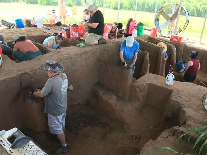 Etzanoa archeological dig site A group of people are digging in a dirt pit.