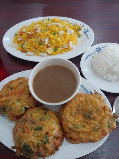A table topped with plates of food and a bowl of soup.