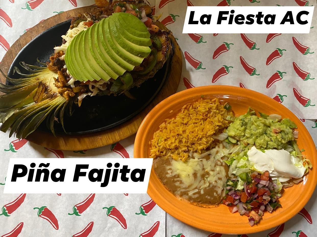 Two plates of food on a table with the words la fiesta ac and piña fajita