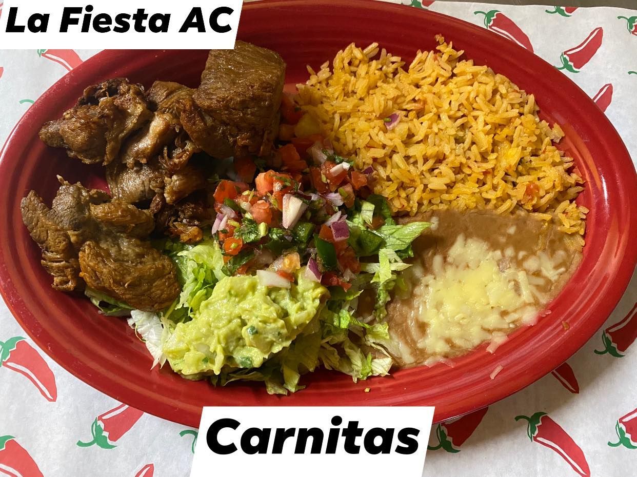 A red plate topped with rice , guacamole , and meat.