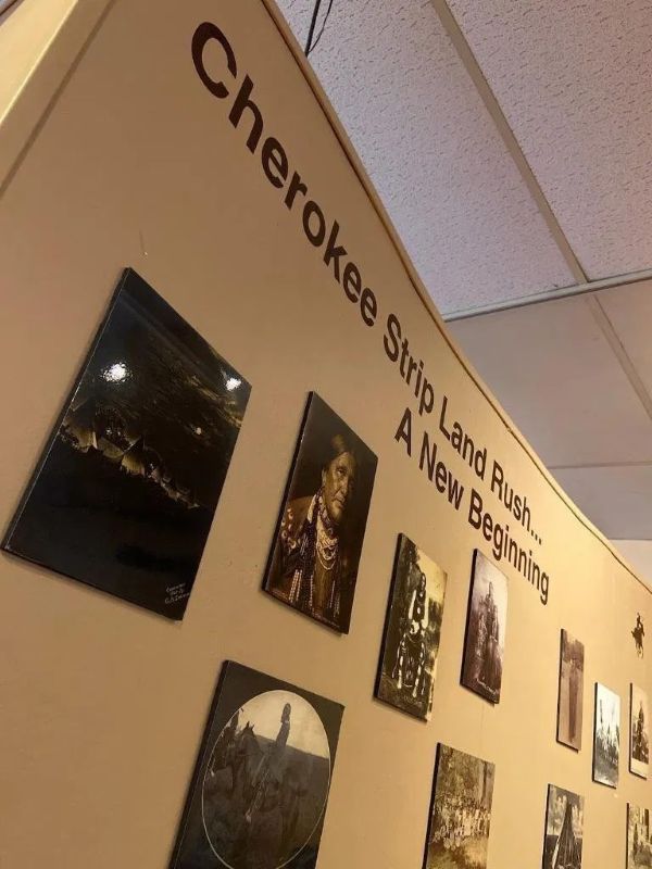 A wall with cherokee strip land rush written on it