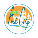 A logo for visit park city with a castle in the background