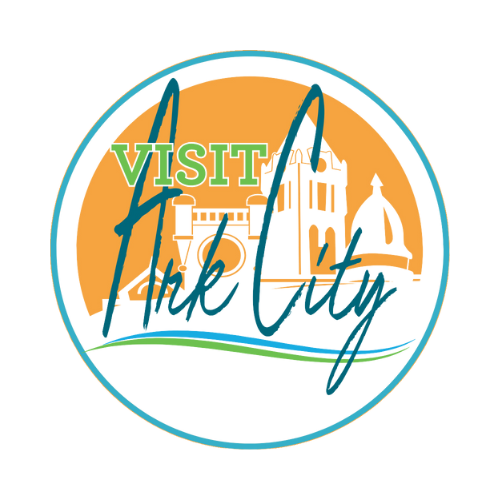 A logo for visit ark city with a castle in the background