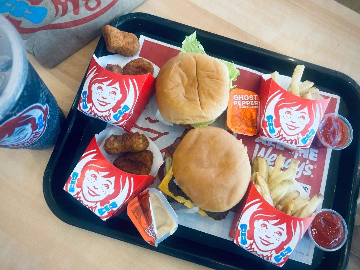 A tray of wendy 's hamburgers french fries and chicken nuggets