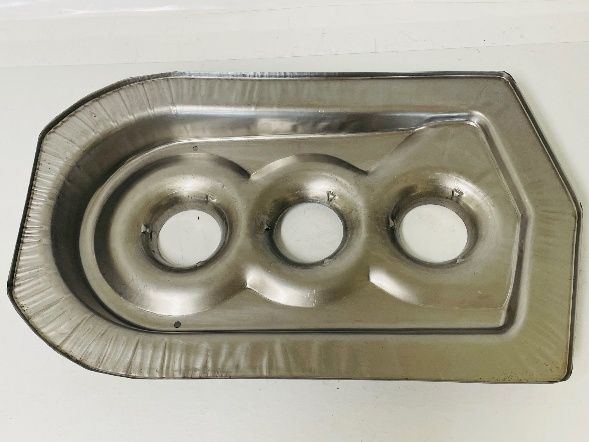 Metal plate with three circular openings and a raised perimeter, likely a part from a machine or vehicle.