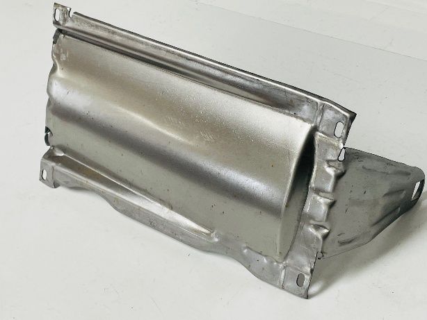 A curved, metal automotive part with a silvery finish and rectangular mounting tabs.
