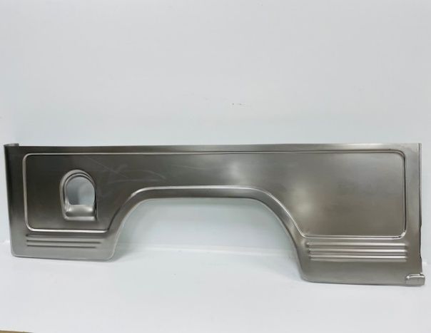 A bare metal vehicle bed side panel with an arch for the wheel well and an opening.